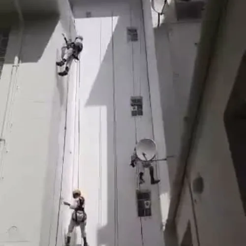 Workers abseiling a high-rise building for facade waterproofing